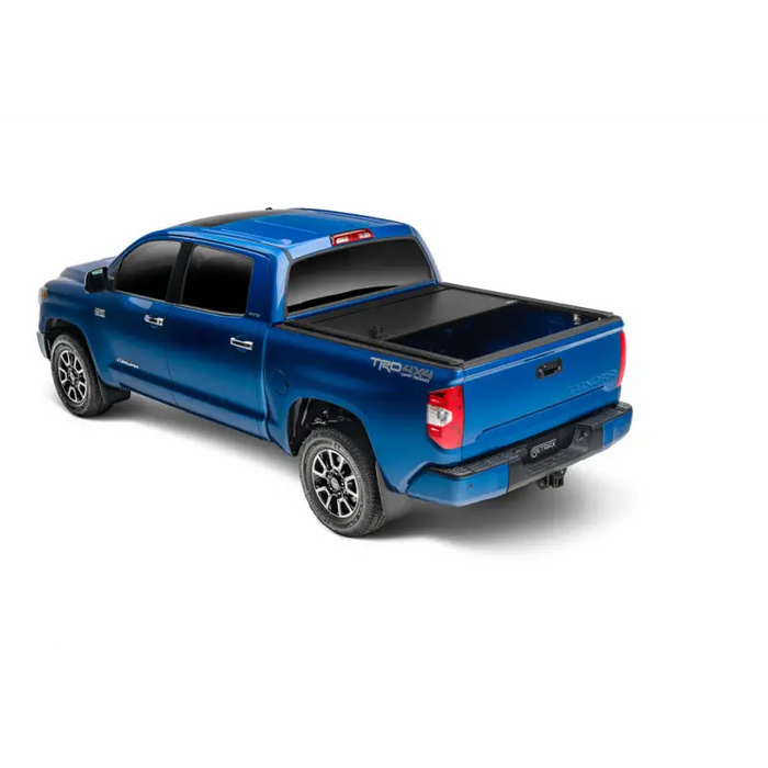 Blue truck with black bed cover - RetraxONE XR trax rail system, cargo capacity for 16-18 Tacoma Double Cab.