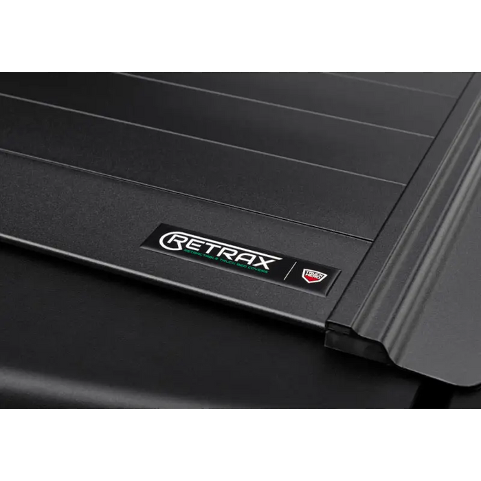 RetraxPRO MX cover logo on Tacoma rear bumper.