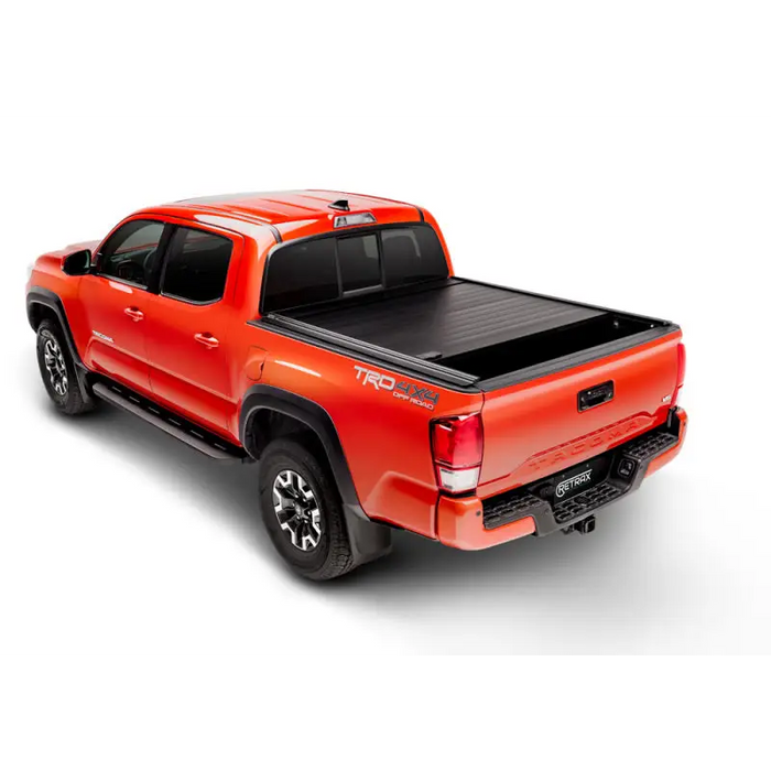 Red truck with black bed cover - RetraxPRO MX for 16-18 Tacoma Double Cab