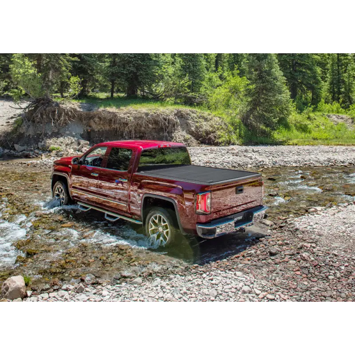 RetraxPRO MX cover on a truck driving through a river