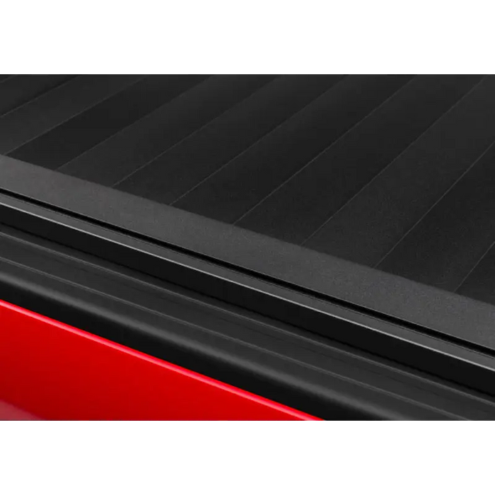 Black RetraxPRO XR truck bed cover with red Tacoma truck bed, trax rail slot accessories