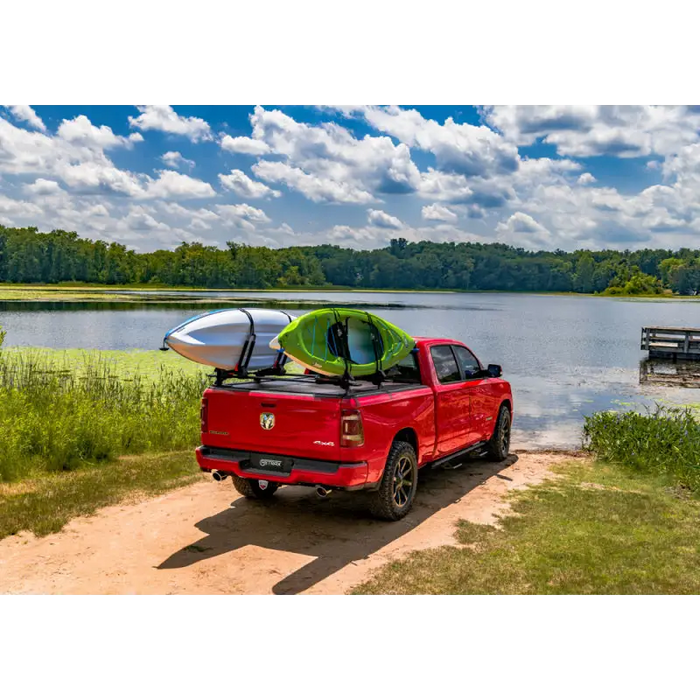 Red truck parked by lake, RetraxPRO XR with trax rail and cargo capacity slot accessories.