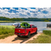 Red truck parked by lake, RetraxPRO XR with trax rail and cargo capacity slot accessories.