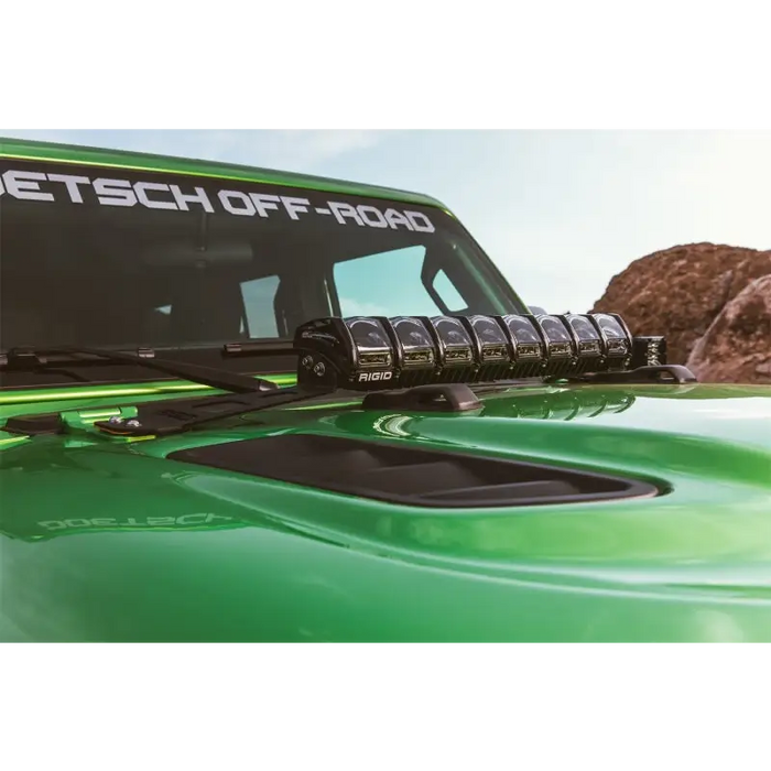 Green truck with black bumper featured in the rigid industries 2018 jeep jl hood mount kit.