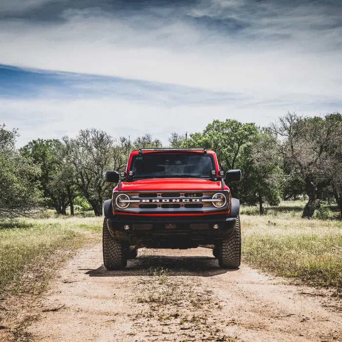 Red jeep parked on dirt road, showcasing Rigid Industries 2021 Ford Bronco Roof Line Light Kit.