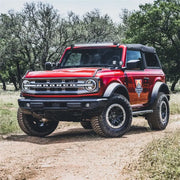 Red truck parked on dirt road with Rigid Industries Ford Bronco Roof Line SR Mount Kit