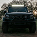 Black truck parked in field showcasing Rigid Industries roof rack light kit.