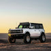 White Ford Bronco truck parked on rocky road with Rigid Industries 2021+ Ford Roof Pod Mount - fits 8 RIGID 4in 360