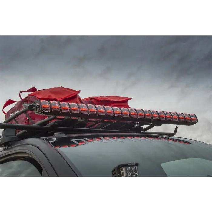 Rigid Industries 20in Adapt Light Bar with red roof rack on car.