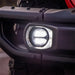 Rigid Industries SAE J583 compliant LED fog lights with white headlight close up