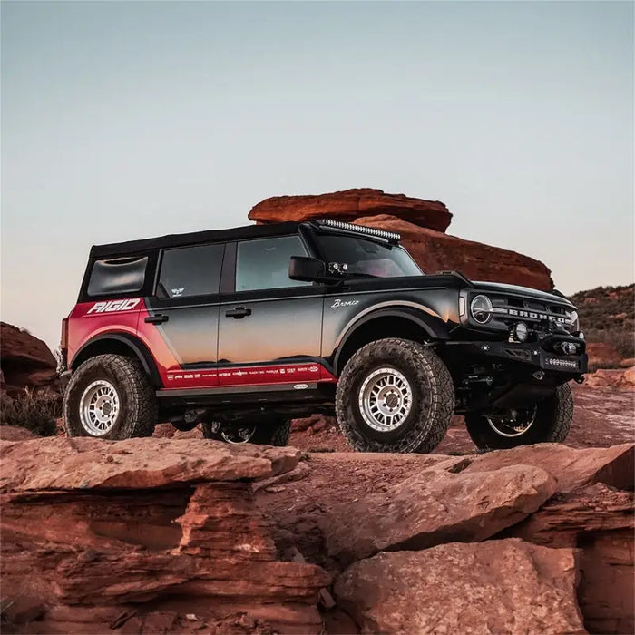 Off-road vehicle parked on rocky hill with rock outcropping next to Revolve light pod - Pair.