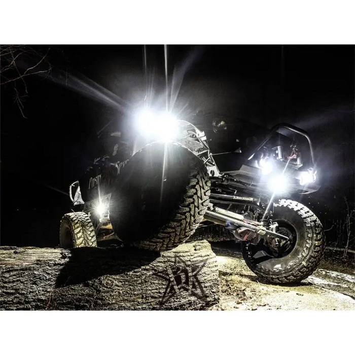 Black ATV with light from Rigid Industries Rock Light Kit - Amber.