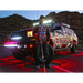 Man standing next to a red rock light kit truck