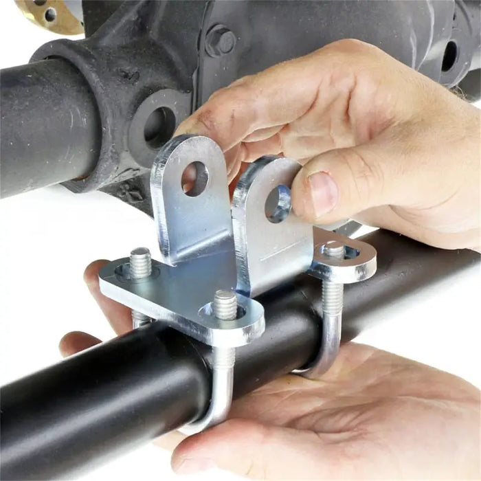 Hand holding a pipe with wren - RockJock JK Currectlync Steering Sys. With Flipped Drag Link and Tie Rod