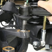 Person holding RockJock JK Currectlync Steering System with Flipped Drag Link and Tie Rod