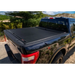 Black truck bed cover for 16-18 Toyota Tacoma with Roll-N-Lock design.