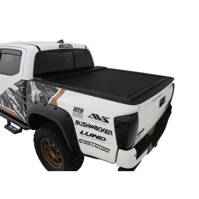 Roll-N-Lock black and white truck bed cover on Toyota Tacoma Access Cab/Double Cab LB 73-11/16in M-Series Tonneau Cover.