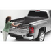 Woman loading truck bed with Roll-N-Lock Cargo Manager for Toyota Tacoma Crew Cab SB.