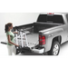 Woman loading a truck bed with tools - Roll-N-Lock Cargo Manager for Toyota Tacoma installation instructions