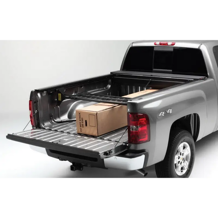 Roll-N-Lock Cargo Manager installation in Toyota Tacoma with truck bed box.