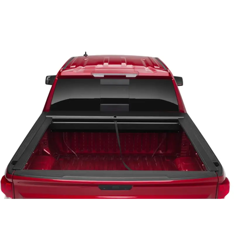 Red car with open trunk lid, Roll-N-Lock retractable truck bed cover for Toyota Tacoma Crew Cab SB.