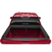 Red car with open trunk lid, Roll-N-Lock retractable truck bed cover for Toyota Tacoma Crew Cab SB.