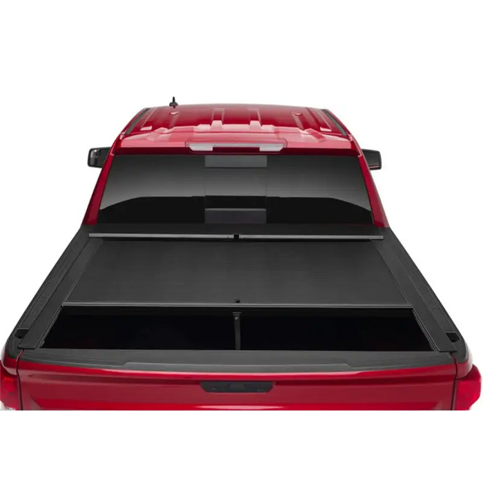 Red truck bed cover open on Toyota Tacoma with Roll-N-Lock design.