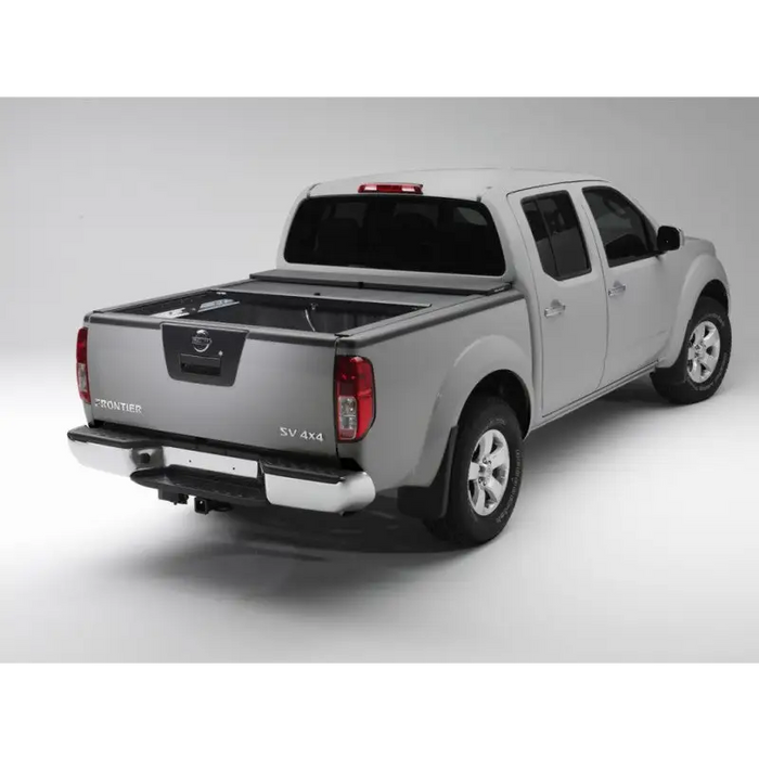 Roll-N-Lock retractable tonneau cover on white truck bed.