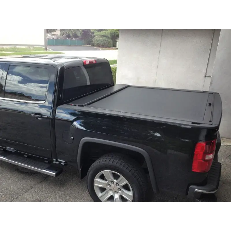 Black Roll-N-Lock retractable truck bed cover for Toyota Tacoma with Crew Cab and Short Bed.