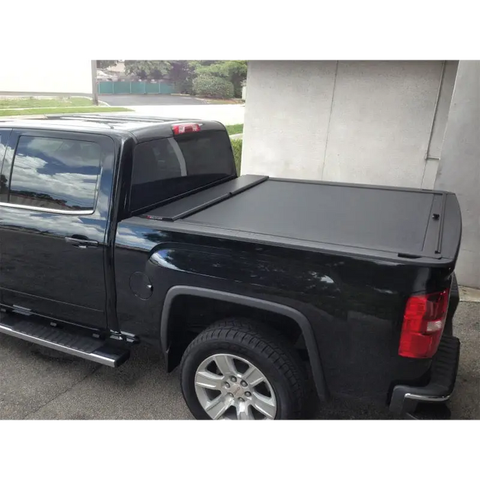 Black Roll-N-Lock retractable truck bed cover for Toyota Tacoma with Crew Cab and Short Bed.