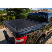 Roll-N-Lock retractable tonneau cover on black truck bed with cover