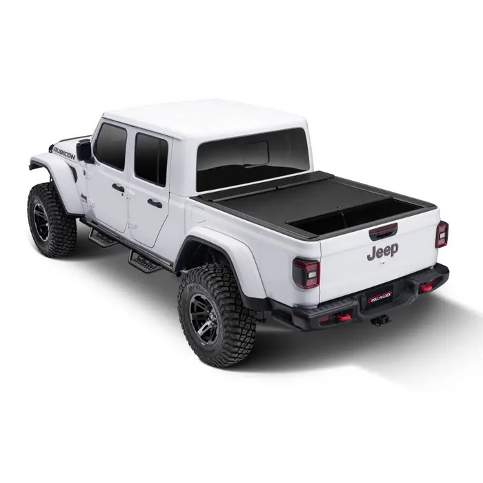 Roll-N-Lock retractable tonneau cover for Jeep Gladiator with black bed cover on white truck