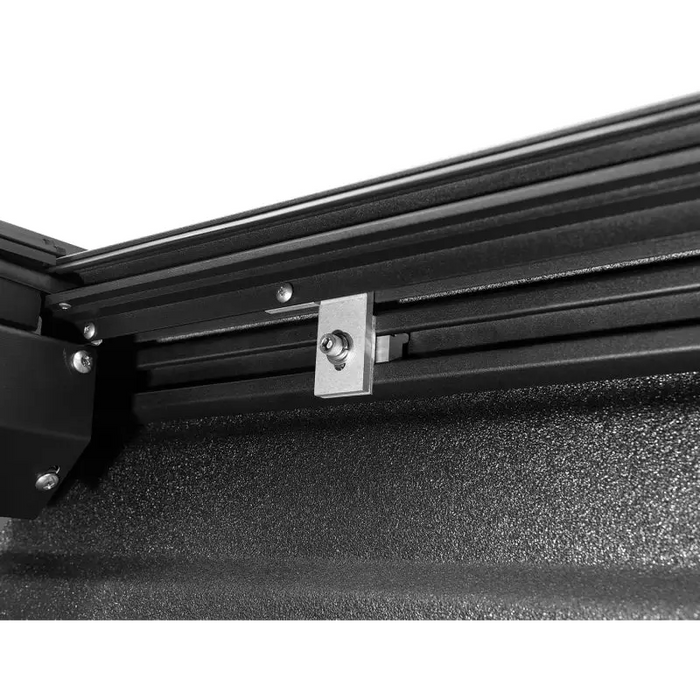 Roll-N-Lock retractable tonneau cover with black steel frame mounted on wall