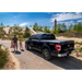 Man and girl walking towards black truck bed cover - Roll-N-Lock 2020 Jeep Gladiator.