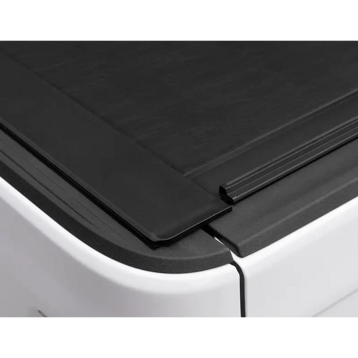 Roll-N-Lock retractable tonneau cover on a Jeep Gladiator truck bed, featuring side window seal for added protection