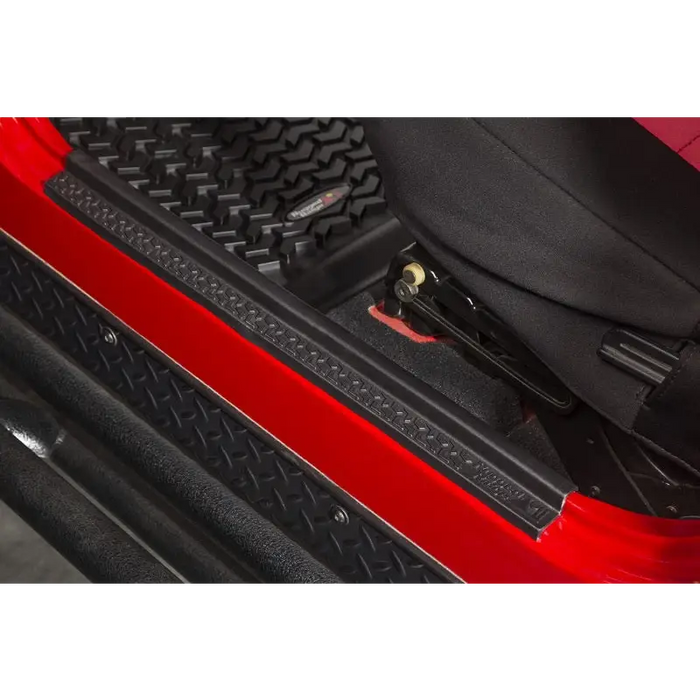 Red car close up showing black seat and bag - Rugged Ridge 04-06 Jeep Wrangler LJ All Terrain Entry Guard Kit