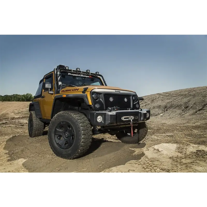 Rugged Ridge Jeep Wrangler XHD Snorkel Kit on dirt road with air intake pre filter low.