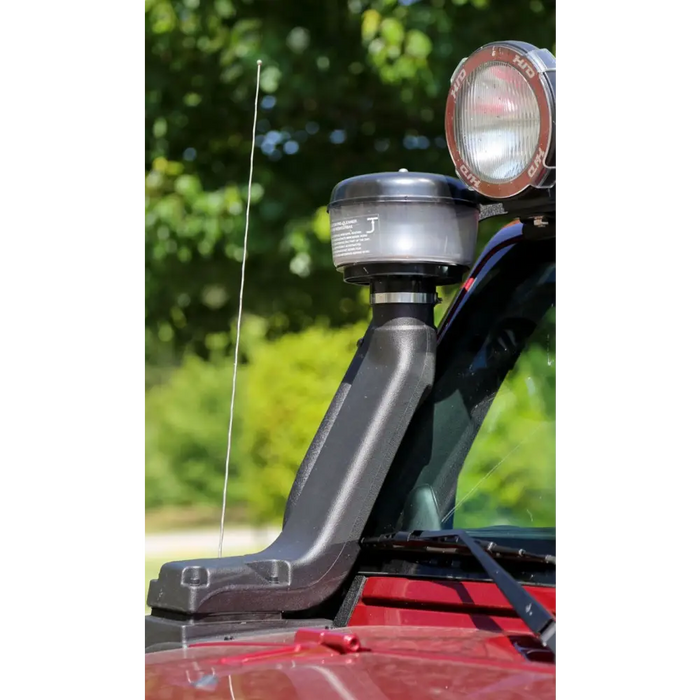 Close up of light on red car hood in Rugged Ridge XHD Snorkel with pre-filter for Jeep Wrangler.