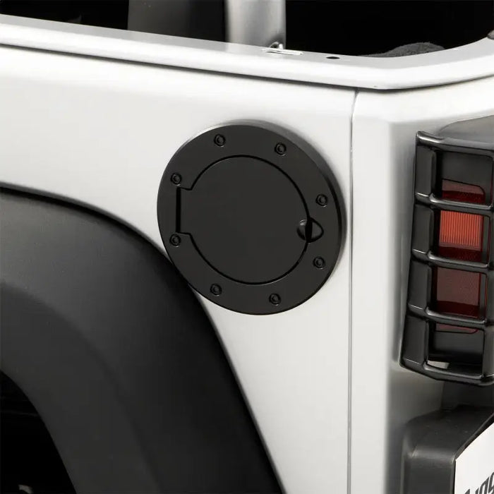 Rugged Ridge non-locking gas cap door for white Jeep Wrangler with red light