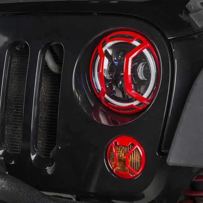 Front end of a Jeep with red LEDs - Rugged Ridge Elite Headlight Euro Guards