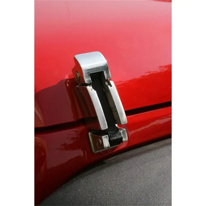 Stainless steel chrome door handle on red car.