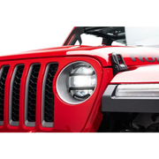 Red Jeep with headlight guards displayed on white background.