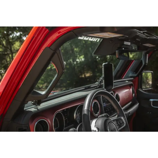 Interior of a red car with Rugged Ridge 18-21 Jeep Wrangler/Gladiator (JL/JT) Dash Bar - Black