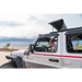 Man driving rugged ridge voyager soft top jeep wrangler on beach.