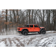 Jeep Gladiator driving on snowy road with Max Terrain fender flares.