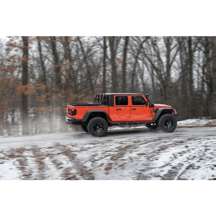 Jeep Gladiator driving on snowy road with Max Terrain fender flares.