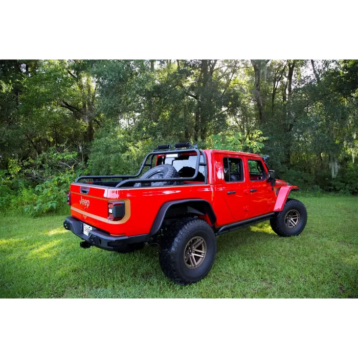 Red truck parked in field near Rugged Ridge Jeep Gladiator roof rack.