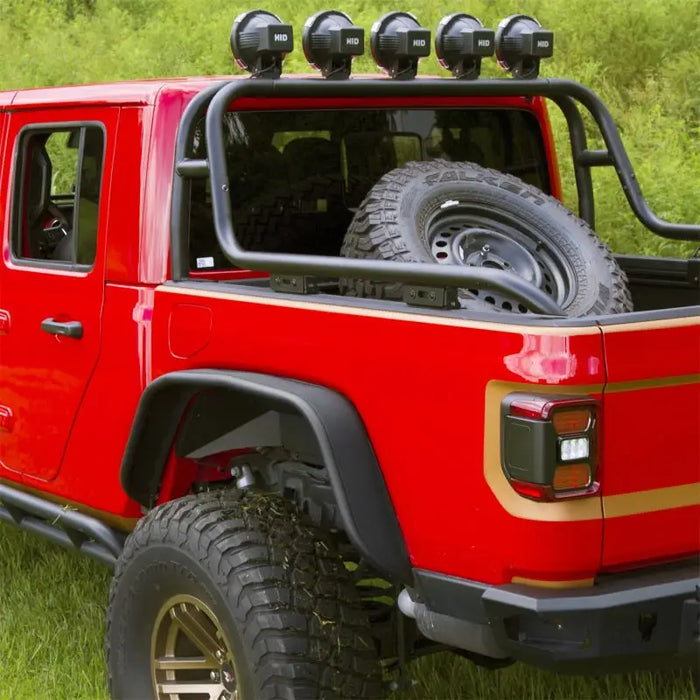 Black steel tube fender kit on a Jeep parked in grass