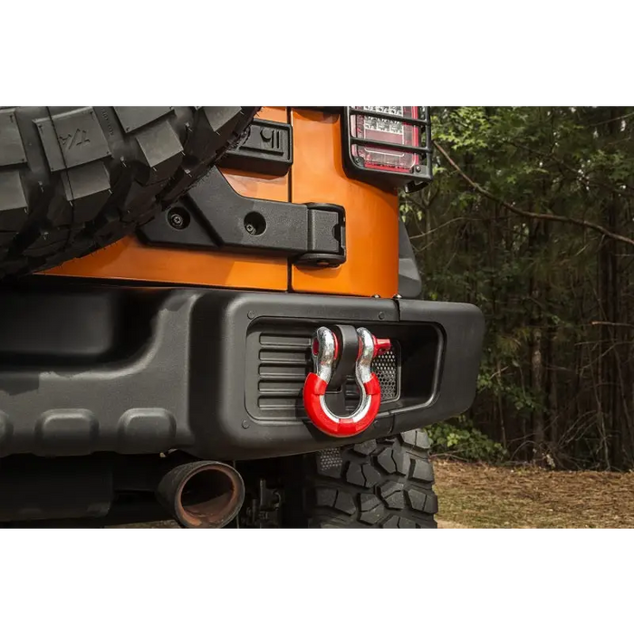 Rugged Ridge red D-ring isolator kit on front of jeep