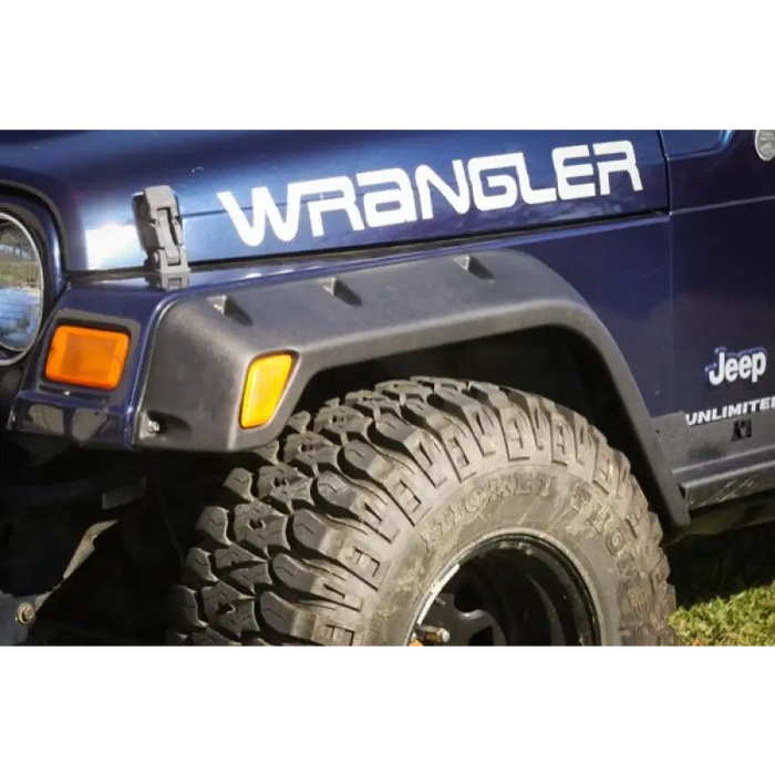Rugged Ridge 4-Piece Fender Flare Kit showcasing a jeep with a large tire on it